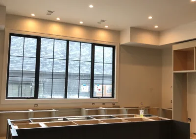 A kitchen is being built with a black counter top.